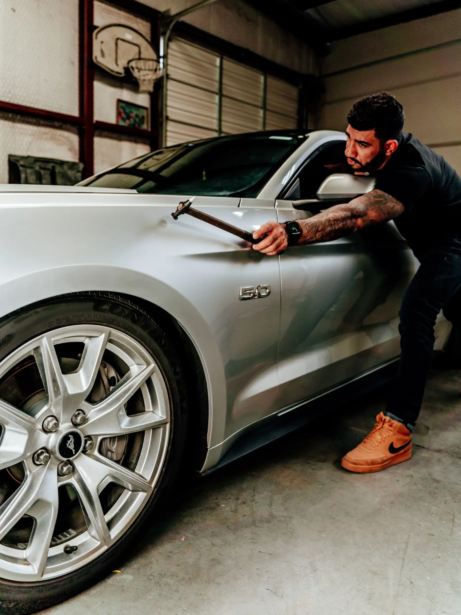 Paintless dent repair on a silver Ford Mustang fender at Hail Repair Pro Lubbock, TX
